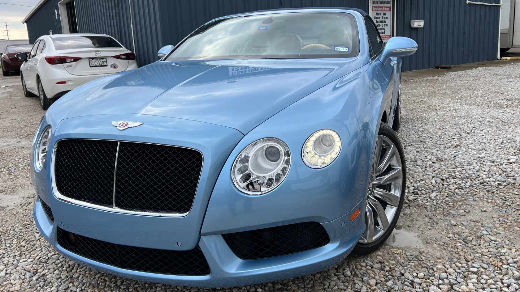 Flawless black paint job on a luxury sedan after body work.