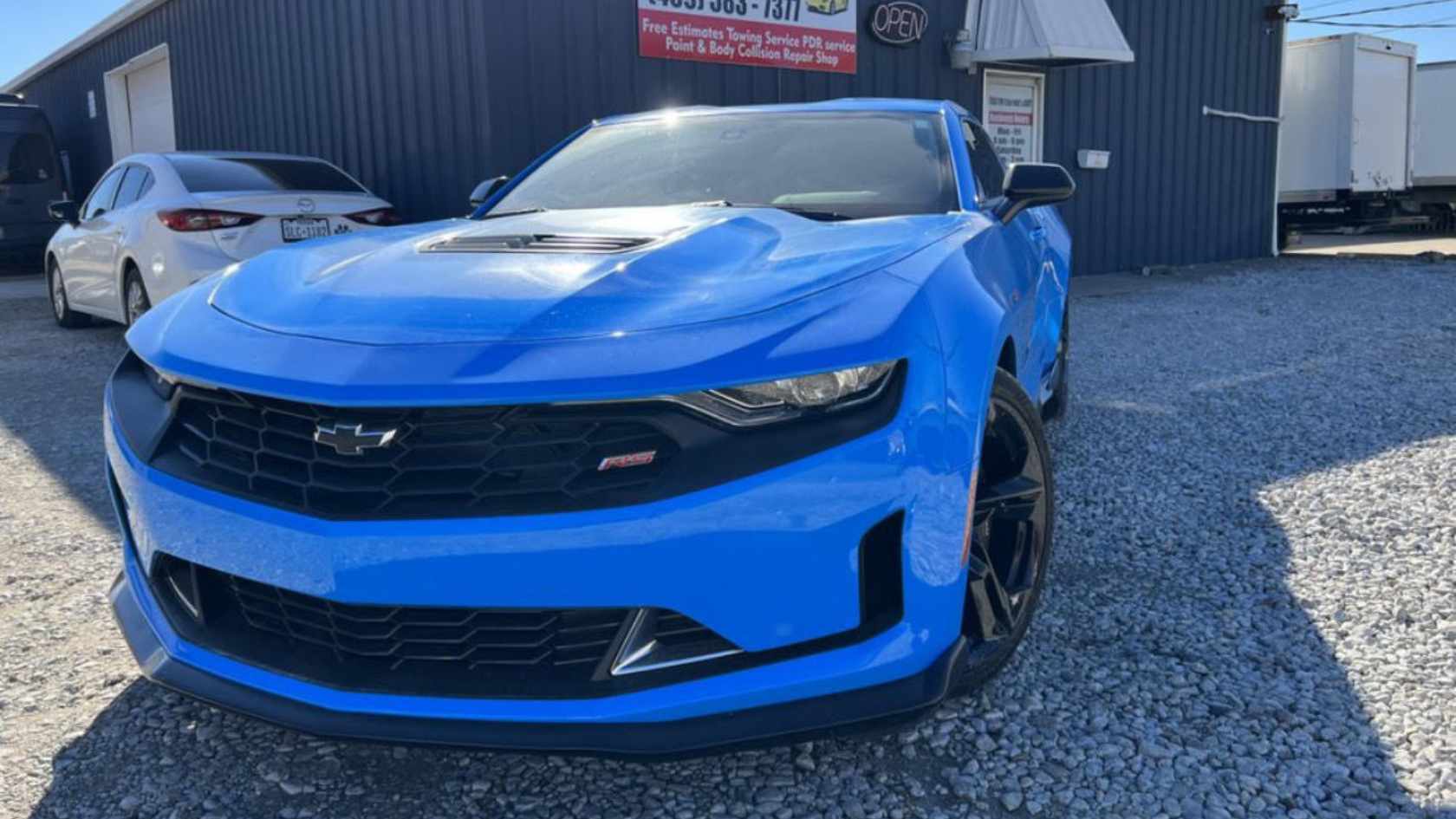 Paintless dent repair results on a car door with hail damage.