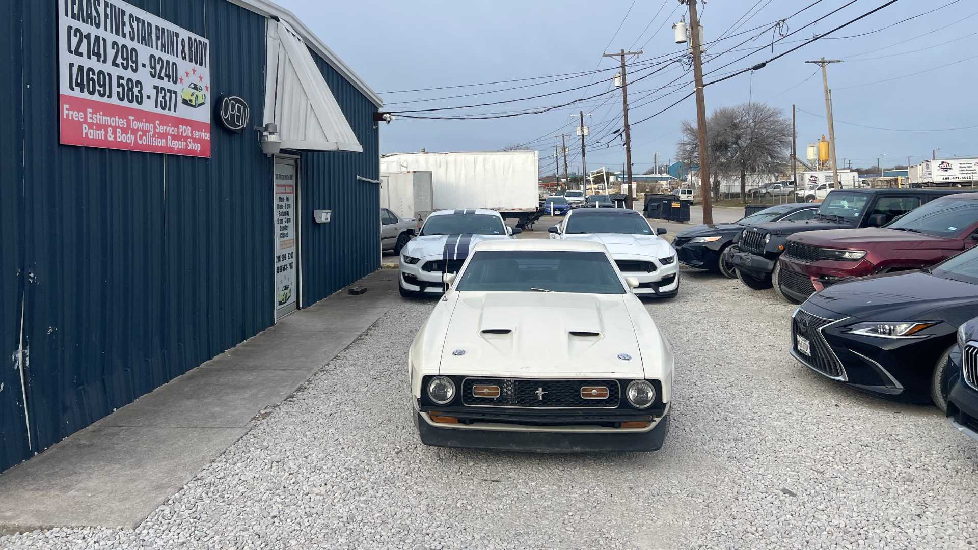 A restored car shining under the lights.